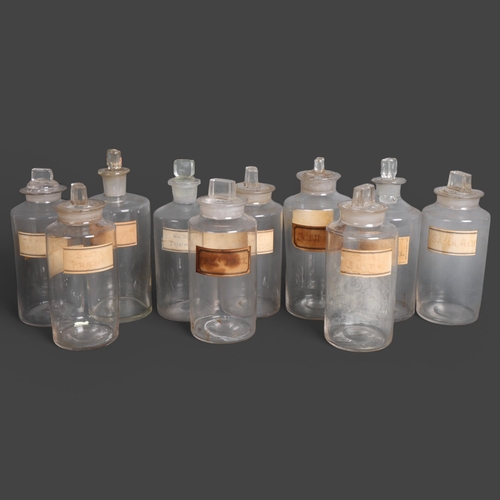 3018 - An group of ten clear glass apothecary bottles, including some hand blown, each with stopper, all wi... 