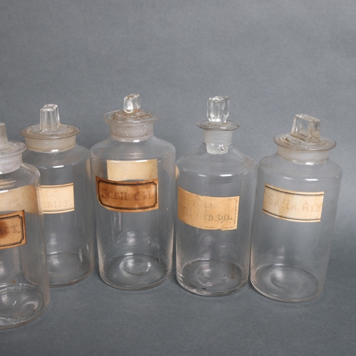 3018 - An group of ten clear glass apothecary bottles, including some hand blown, each with stopper, all wi... 