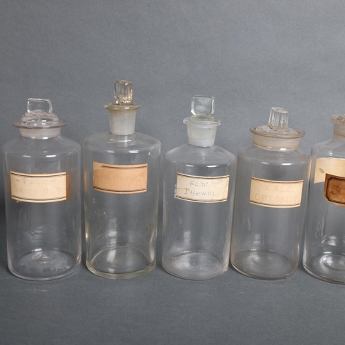 3018 - An group of ten clear glass apothecary bottles, including some hand blown, each with stopper, all wi... 