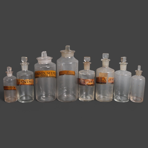 3022 - A group of six clear glass apothecary bottles, each with stopper, all have gold gilt period labels, ... 