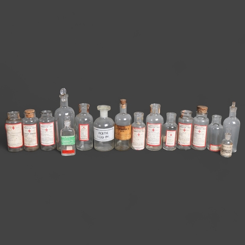 3023 - A group of clear glass apothecary bottles, some corked and labelled, some with glass stoppers, varyi... 