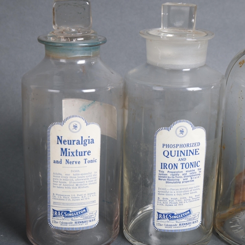 3033 - Two nice clear glass apothecary bottles, with stoppers and nice period white paper labels, and, a la... 