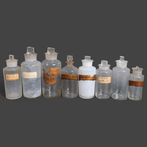 3034 - A group of eight clear glass apothecary bottles, mixed sizes, one very old fine glass bottle, all wi... 