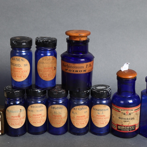 3035 - A collection of seven cobalt blue poison bottles with metal stoppers, all with labels relating to 'S... 