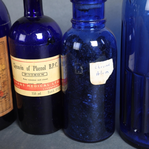 3039 - A group of four blue glass apothecary bottles, including three labelled, example label reads 'Glycer... 