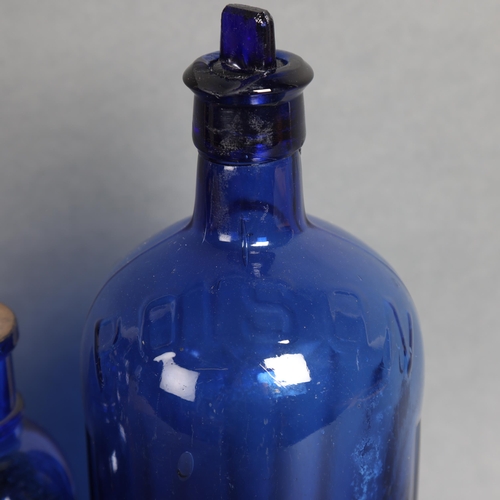 3039 - A group of four blue glass apothecary bottles, including three labelled, example label reads 'Glycer... 