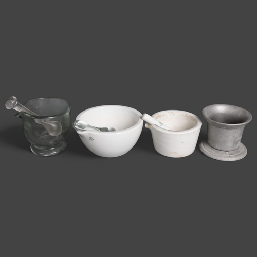 3046 - A group of three various pestle and mortars, one glass and two ceramic, and another pestle.