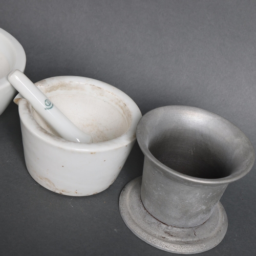 3046 - A group of three various pestle and mortars, one glass and two ceramic, and another pestle.