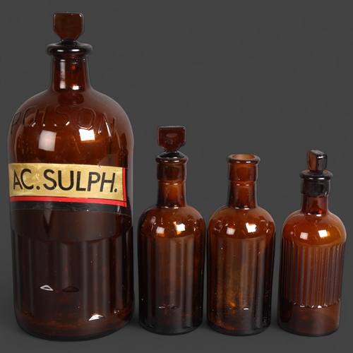 3050 - A group of four brown glass apothecary bottles, one large and three small, largest with stopper and ... 