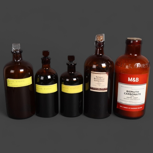 3051 - A group of five amber glass apothecary bottles, each with stoppers of varying types, all with paper ... 