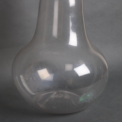 3054 - A large antique bell shaped Chemist bottle with stopper, height 46cm.