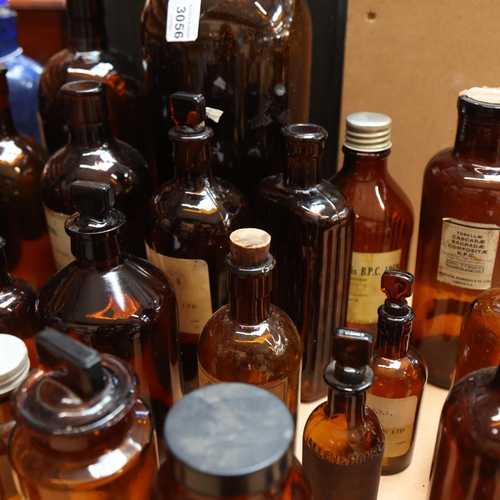 3056 - A large quantity of amber glass apothecary bottles, mixed sizes and styles, some stoppers present, s... 