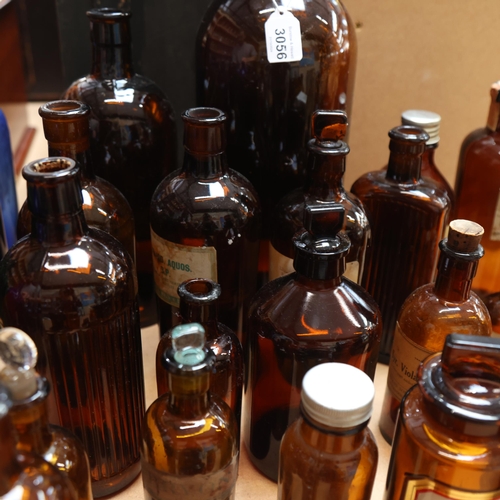 3056 - A large quantity of amber glass apothecary bottles, mixed sizes and styles, some stoppers present, s... 