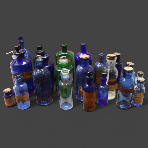 3057 - A quantity of blue and green glass apothecary bottles, mixed sizes and varying designs, some with or... 