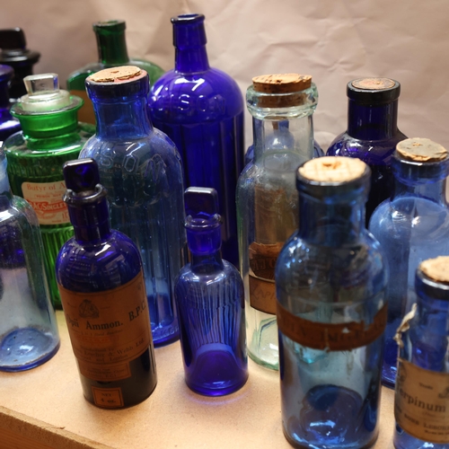 3057 - A quantity of blue and green glass apothecary bottles, mixed sizes and varying designs, some with or... 