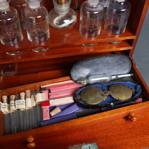 3059 - An antique teak travelling apothecary cabinet, fitted with etched glass bottles and test tubes, alon... 