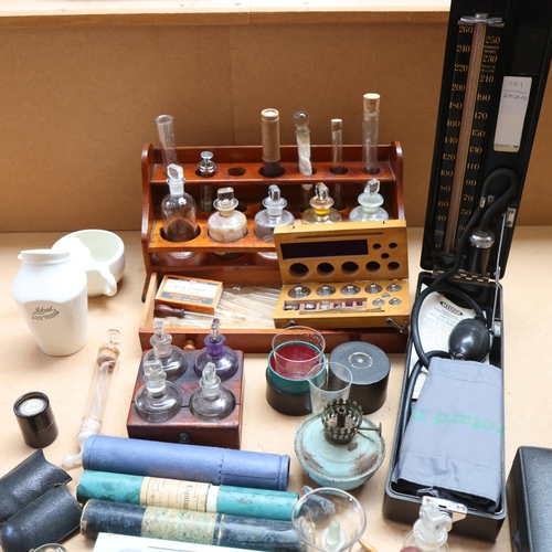 3062 - A antique teak laboratory rack with fitted drawer and a selection of clear glass apothecary bottles ... 