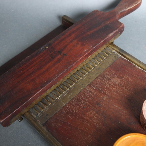 3067 - An antique apothecary pill roller, unmarked, with wooden dish and terracotta pot with lid.