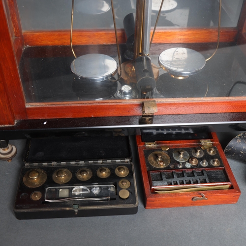 3073 - A mahogany-cased set of brass balance scales, by Gertling of London, on stand, together with 2 sets ... 