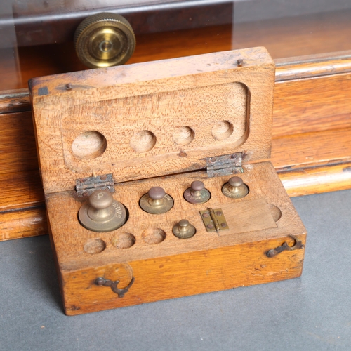 3075 - A pair of antique laboratory balance scales, house in an oak glazed cased, scales manufactured by Gr... 