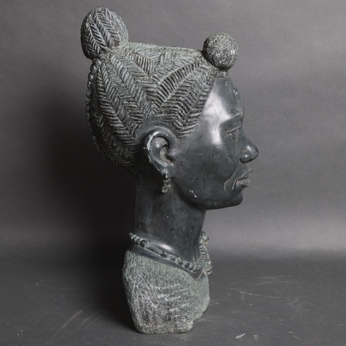 3094 - A large green stone bust of an African woman, unsigned, height 45cm.