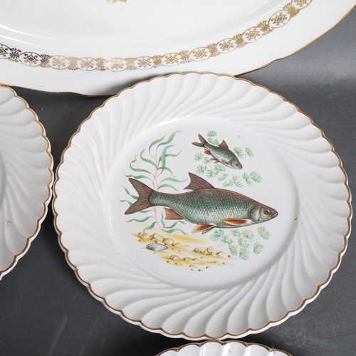 3103 - Luneville, a group of 12 ceramic dinner plates and an oval meat plate, all with decorative fish desi... 