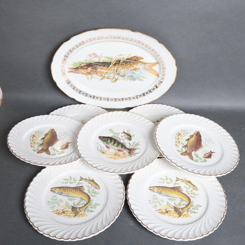 3103 - Luneville, a group of 12 ceramic dinner plates and an oval meat plate, all with decorative fish desi... 