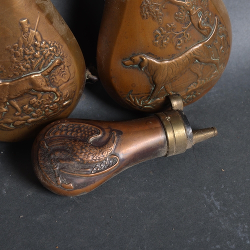 3105 - A group of three copper powder flasks, with embossed hunting scene decoration, (3).