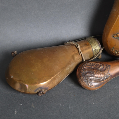 3105 - A group of three copper powder flasks, with embossed hunting scene decoration, (3).