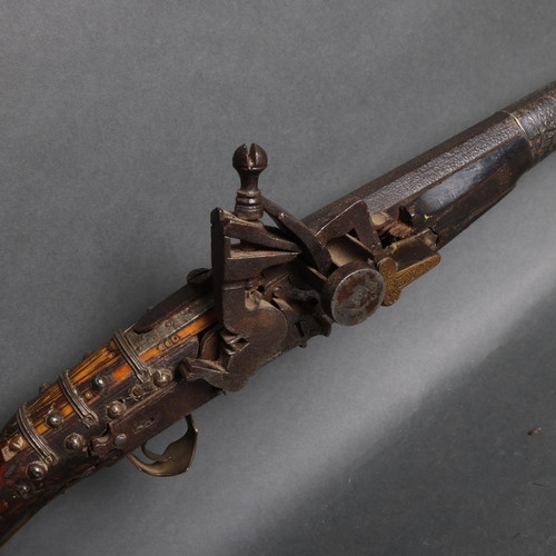 3107 - A 19th century Moroccan flint lock rifle(moukahla), with inlaid decoration and engraved white metal ... 