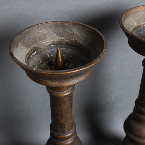 3111 - A pair of bronze prickett candlesticks, height 32cm.