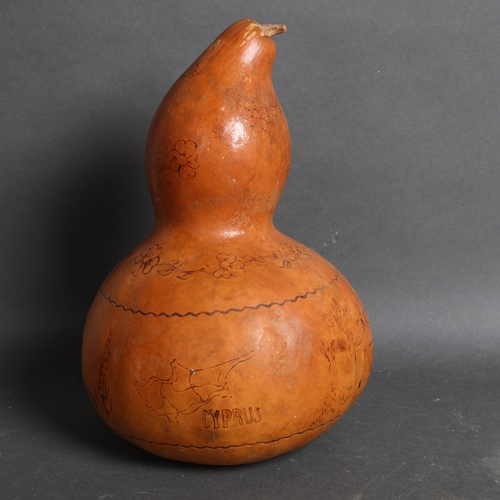 3114 - An incised and decorated gourd depicting animals and figures 