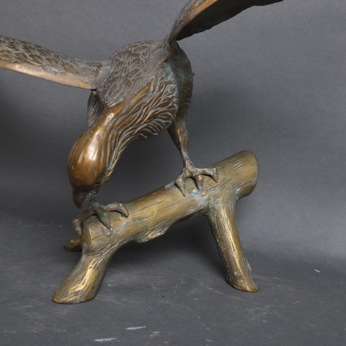 3128 - A brass sculpture of an Eagle perched on branch, unsigned height 47cm.