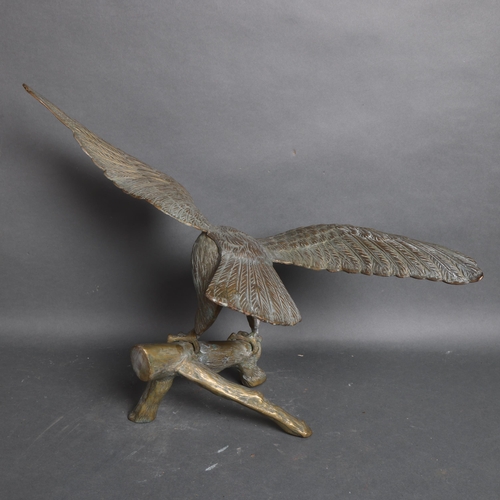 3128 - A brass sculpture of an Eagle perched on branch, unsigned height 47cm.