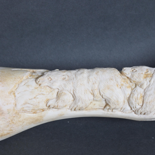 3145 - Carved Buffalo bone depicting Bears
The bone retaining original shape but decoratively carved at eit... 