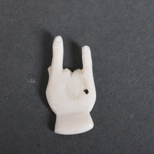 3149 - Amulet Hand-Carved from buffalo bone in the form of a hand in the “sign of the horns” 
For use in re... 