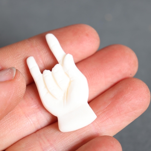 3149 - Amulet Hand-Carved from buffalo bone in the form of a hand in the “sign of the horns” 
For use in re... 