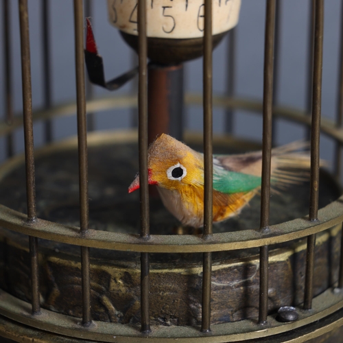 3166 - A small brass cased bird cage automaton clock, with bird, height 13cm.