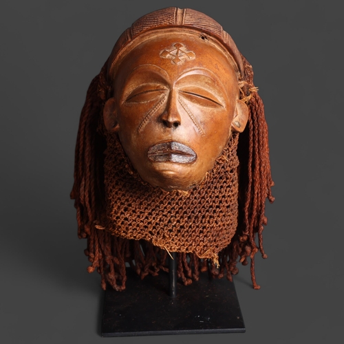 3393 - Chokwe (Uganda), a tribal mask on metal stand, unsigned, height 13cm.