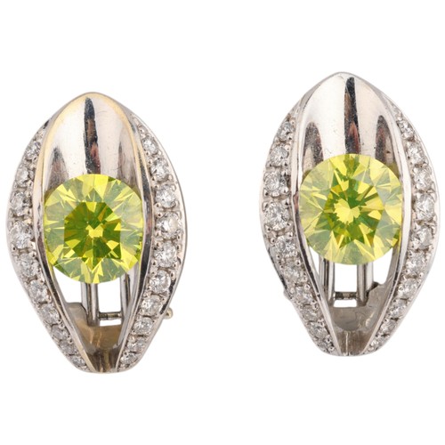 49 - A Fancy Greenish Yellow Diamond and Diamond Demi-Parure, 

each of matching openwork eye design cent... 