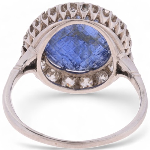 6 - An Antique Mughal Sapphire and Diamond Cluster Ring, 

claw set with a round cabochon Mughal carved ... 