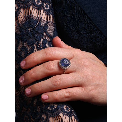 6 - An Antique Mughal Sapphire and Diamond Cluster Ring, 

claw set with a round cabochon Mughal carved ... 