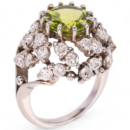 77 - A Peridot and Diamond Cocktail Ring, 

circa 1950, the bombe cluster centrally claw set with a round... 