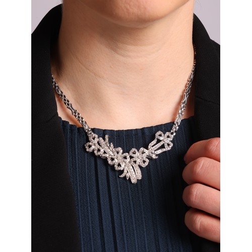 46 - A Diamond Collar Necklace, 

the pendant designed as a series of ribbon bows, and pave set with mode... 