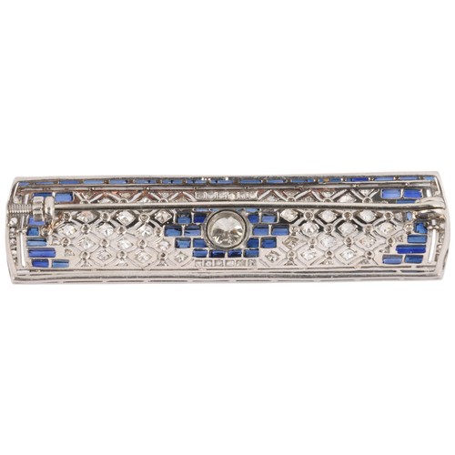 27 - An Art Deco Sapphire and Diamond Plaque Brooch,

circa 1920, the rounded rectangular geometric panel... 