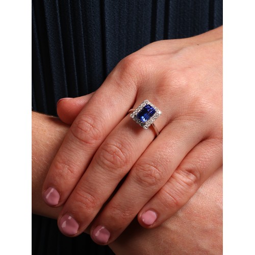 44 - A Tanzanite and Diamond Cluster Ring,

the rectangular panel set with an octagonal step cut Tanzanit... 