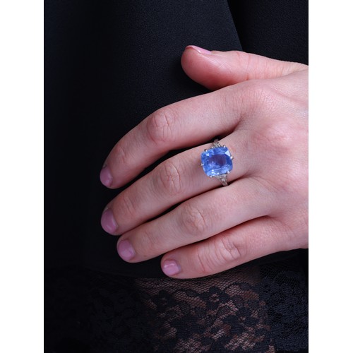 20 - A Sri Lankan No Heat Sapphire and Diamond Ring,

circa 1910, claw set with a cushion cut sapphire of... 