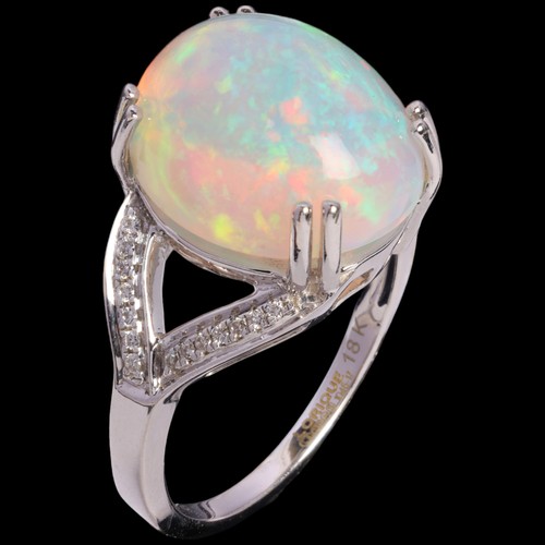 64 - An Ethiopian Opal and Diamond Ring, 

set with an oval cabochon opal of approximately 7.00 carats, f... 