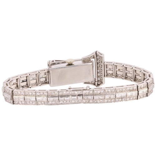 68 - An Art Deco Lady's Platinum and Diamond Bracelet Watch, 

circa 1930, the rectangular silvered dial ... 