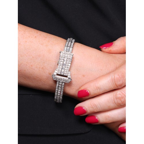 68 - An Art Deco Lady's Platinum and Diamond Bracelet Watch, 

circa 1930, the rectangular silvered dial ... 